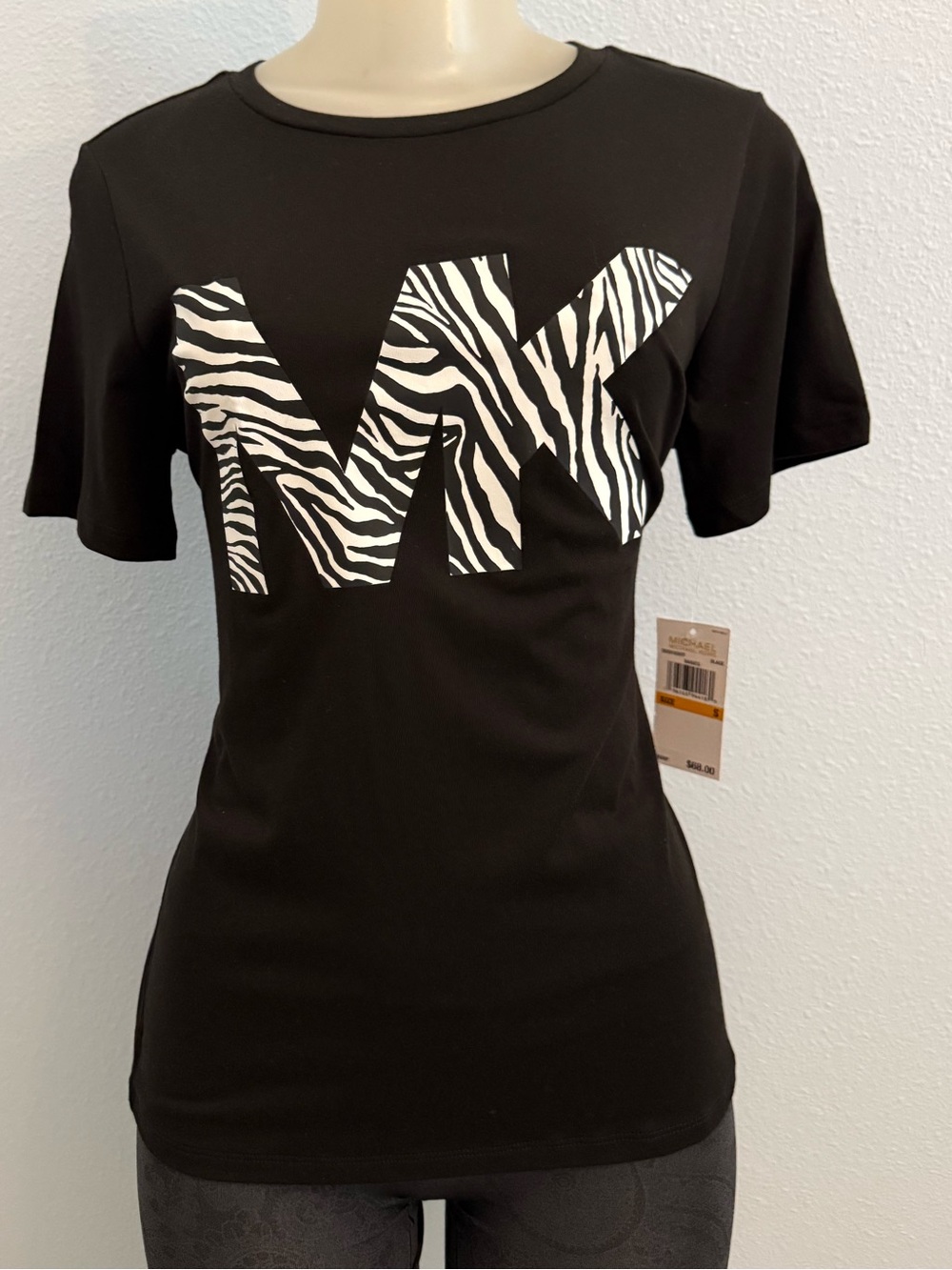 Michael Kors Black Tee with White Zebra MK Logo. New with Tags